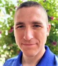 Headshot of man in blue polo